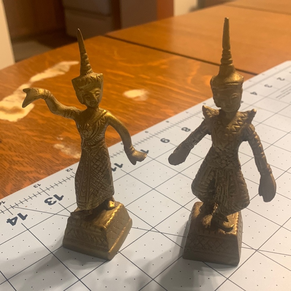 Dancing brass metallic dolls